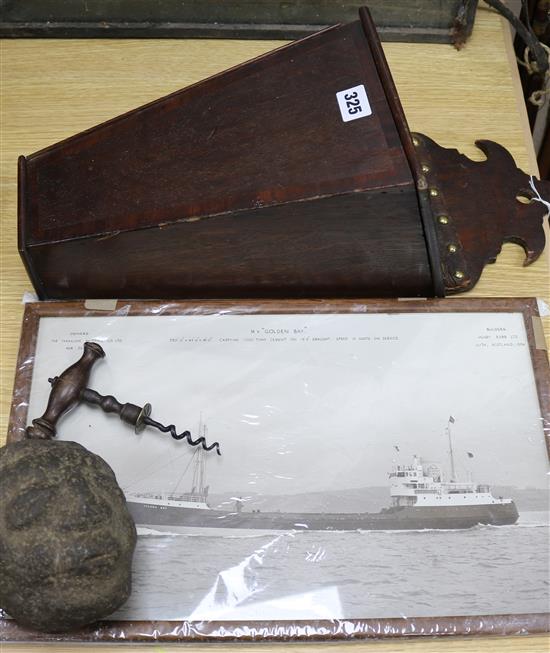 A carved stone head, candle box, corkscrew and photo of MV Golden Bay